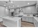 Modern kitchen with gray cabinetry, a large island, stainless steel appliances, and marble countertops at 10300 Stroma Ave, Las Vegas, NV 89166