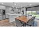 Open-concept kitchen and dining area with stainless steel appliances and sliding glass doors to the backyard at 10300 Stroma Ave, Las Vegas, NV 89166