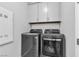 Laundry area featuring gray washer and dryer with gray overhead cabinets at 10300 Stroma Ave, Las Vegas, NV 89166