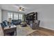 Comfortable living room features large windows, hardwood floors, and stylish furnishings, creating a cozy atmosphere at 10300 Stroma Ave, Las Vegas, NV 89166