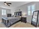 Elegant main bedroom with a ceiling fan, plantation shutters, stylish furniture, and a cozy atmosphere at 10300 Stroma Ave, Las Vegas, NV 89166