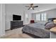 Spacious main bedroom with a ceiling fan, plantation shutters, a TV, and a comfortable seating area at 10300 Stroma Ave, Las Vegas, NV 89166