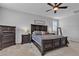 Elegant main bedroom with dark wood furniture, plantation shutters, and a ceiling fan at 10300 Stroma Ave, Las Vegas, NV 89166