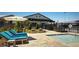 Relaxing poolside area with lounge chairs, umbrellas, and a serene atmosphere at 10300 Stroma Ave, Las Vegas, NV 89166