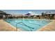 Large outdoor swimming pool with lane markers and a paved deck for lounging at 10300 Stroma Ave, Las Vegas, NV 89166