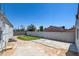 A well-maintained backyard with a combination of concrete patio, brick wall, and some grass at 1123 Chapman Dr, Las Vegas, NV 89104