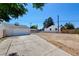 Spacious backyard area featuring a detached garage and a concrete driveway at 1123 Chapman Dr, Las Vegas, NV 89104