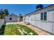 Lush backyard featuring a detached garage, grassy areas, and concrete pavers at 1123 Chapman Dr, Las Vegas, NV 89104