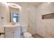 Bathroom featuring marble-tiled walls, recessed niche, modern sink, and updated fixtures at 1123 Chapman Dr, Las Vegas, NV 89104