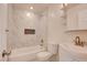 Bathroom featuring bathtub, sink, storage, and marble tiling at 1123 Chapman Dr, Las Vegas, NV 89104
