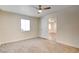 Comfortable bedroom featuring carpet flooring, a window, and a ceiling fan for air circulation at 1123 Chapman Dr, Las Vegas, NV 89104