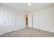 Bedroom featuring neutral carpet and two doors, one leading to the kitchen at 1123 Chapman Dr, Las Vegas, NV 89104