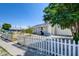 Quaint one-story house featuring a white picket fence, grassy area, and tree for curb appeal at 1123 Chapman Dr, Las Vegas, NV 89104