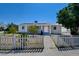 Charming single-story home with a white picket fence and well-maintained front yard at 1123 Chapman Dr, Las Vegas, NV 89104