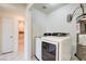 Laundry area featuring marble tiling, a Samsung washer and dryer and water heater at 1123 Chapman Dr, Las Vegas, NV 89104