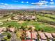 Stunning aerial view of a home on a lush green golf course with mountain views and blue skies at 1131 Golf Club, Laughlin, NV 89029