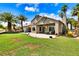 An outdoor patio area has a seating area, and a spacious backyard with green grass and desert landscaping at 1131 Golf Club, Laughlin, NV 89029