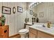 Powder room with wallpaper, picture frames, and wood-look floors at 1131 Golf Club, Laughlin, NV 89029