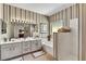 Bathroom with a soaking tub, dual sinks, and a large mirror at 1131 Golf Club, Laughlin, NV 89029