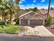 Charming single-story home featuring a two-car garage, desert landscaping, and a tile roof at 1131 Golf Club, Laughlin, NV 89029