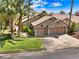Charming single-story home featuring a two-car garage, desert landscaping, and a tile roof at 1131 Golf Club, Laughlin, NV 89029
