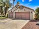 Two car garage with mature trees in front at 1131 Golf Club, Laughlin, NV 89029