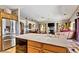 Bright kitchen featuring a functional island, view of living room, and stainless steel appliances at 1131 Golf Club, Laughlin, NV 89029
