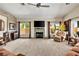 Cozy living room with a brick fireplace, ceiling fan, and plush carpeting at 1131 Golf Club, Laughlin, NV 89029