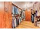 Walk-in closet with custom wood built-ins and ample storage space for clothes and accessories at 1235 Panini Dr, Henderson, NV 89052