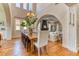 Elegant dining room with hardwood floors, large windows, and a stylish chandelier above a long wooden table at 1235 Panini Dr, Henderson, NV 89052