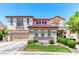 Spacious two-story home featuring a red-tile roof, balconies, well-maintained landscaping, and an attached two-car garage at 1235 Panini Dr, Henderson, NV 89052