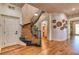 Inviting foyer features a curved staircase, hardwood floors, and an elegant chandelier at 1235 Panini Dr, Henderson, NV 89052