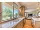 Modern kitchen featuring stone countertops, ample natural light, and stainless steel appliances at 1235 Panini Dr, Henderson, NV 89052