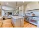 A kitchen boasts a large island, hardwood floors, and stainless steel appliances adjacent to living area at 1235 Panini Dr, Henderson, NV 89052