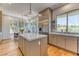 Bright, modern kitchen with stainless steel appliances, island, and large windows at 1235 Panini Dr, Henderson, NV 89052