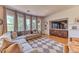 Cozy living room with large windows, a comfortable sectional sofa, and built-in shelving at 1235 Panini Dr, Henderson, NV 89052