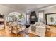 Bright living room featuring hardwood floors, a fireplace, and an open archway to the dining area at 1235 Panini Dr, Henderson, NV 89052