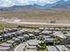 High-angle view of a neighborhood featuring modern homes, scenic mountain backdrops and desert landscape at 12426 Alpenglow Ct, Las Vegas, NV 89138