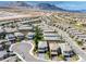 High-angle view of a residential area with neatly aligned homes, complemented by a desert mountain range at 12426 Alpenglow Ct, Las Vegas, NV 89138