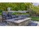This backyard features mature landscaping with an outdoor fireplace and seating area at 12426 Alpenglow Ct, Las Vegas, NV 89138