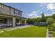 The landscaped backyard features artificial grass, a patio, and an outdoor seating area at 12426 Alpenglow Ct, Las Vegas, NV 89138