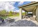 This backyard features a covered patio, an outdoor kitchen, and desert landscaping at 12426 Alpenglow Ct, Las Vegas, NV 89138