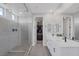 Modern bathroom with a glass shower, dual sinks, and a view into the closet at 12426 Alpenglow Ct, Las Vegas, NV 89138
