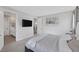 Relaxing bedroom with muted color palette, wall-mounted TV, and an ensuite bathroom at 12426 Alpenglow Ct, Las Vegas, NV 89138
