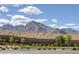 A well maintained community landscape is set against the backdrop of picturesque mountains and a vibrant blue sky at 12426 Alpenglow Ct, Las Vegas, NV 89138