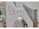 Inviting foyer featuring hardwood floors, a staircase, and a bench at 12426 Alpenglow Ct, Las Vegas, NV 89138