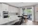 Bright kitchen and dining area with stainless steel appliances and granite countertops at 12426 Alpenglow Ct, Las Vegas, NV 89138