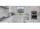Modern kitchen with stainless steel appliances, granite countertops, and white cabinets at 12426 Alpenglow Ct, Las Vegas, NV 89138