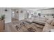 Open concept living room flowing into kitchen with hardwood floors and comfortable seating at 12426 Alpenglow Ct, Las Vegas, NV 89138