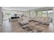Bright living room with hardwood floors, comfortable seating, and sliding glass doors at 12426 Alpenglow Ct, Las Vegas, NV 89138